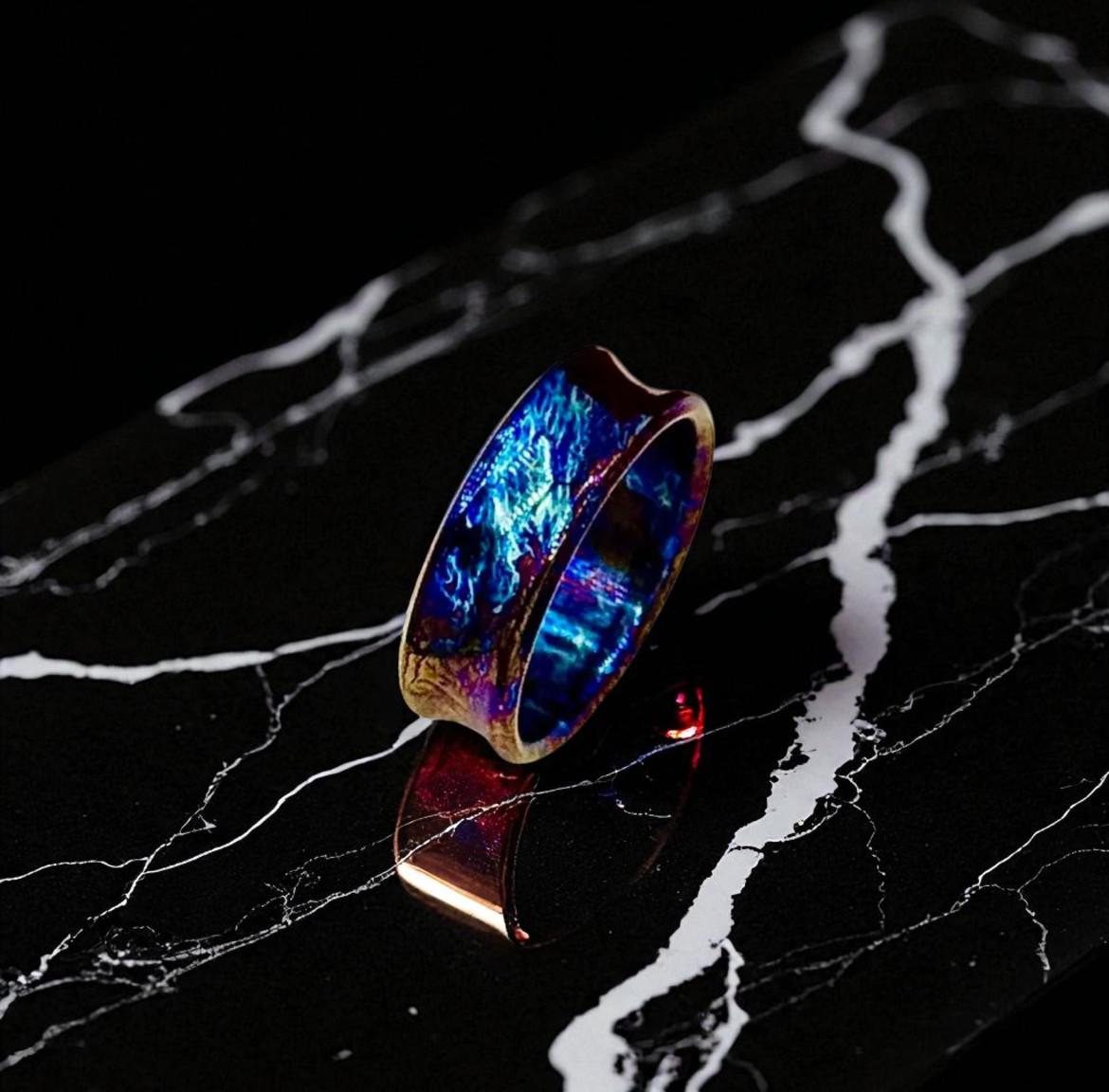 Multicolored ring on a black marble surface