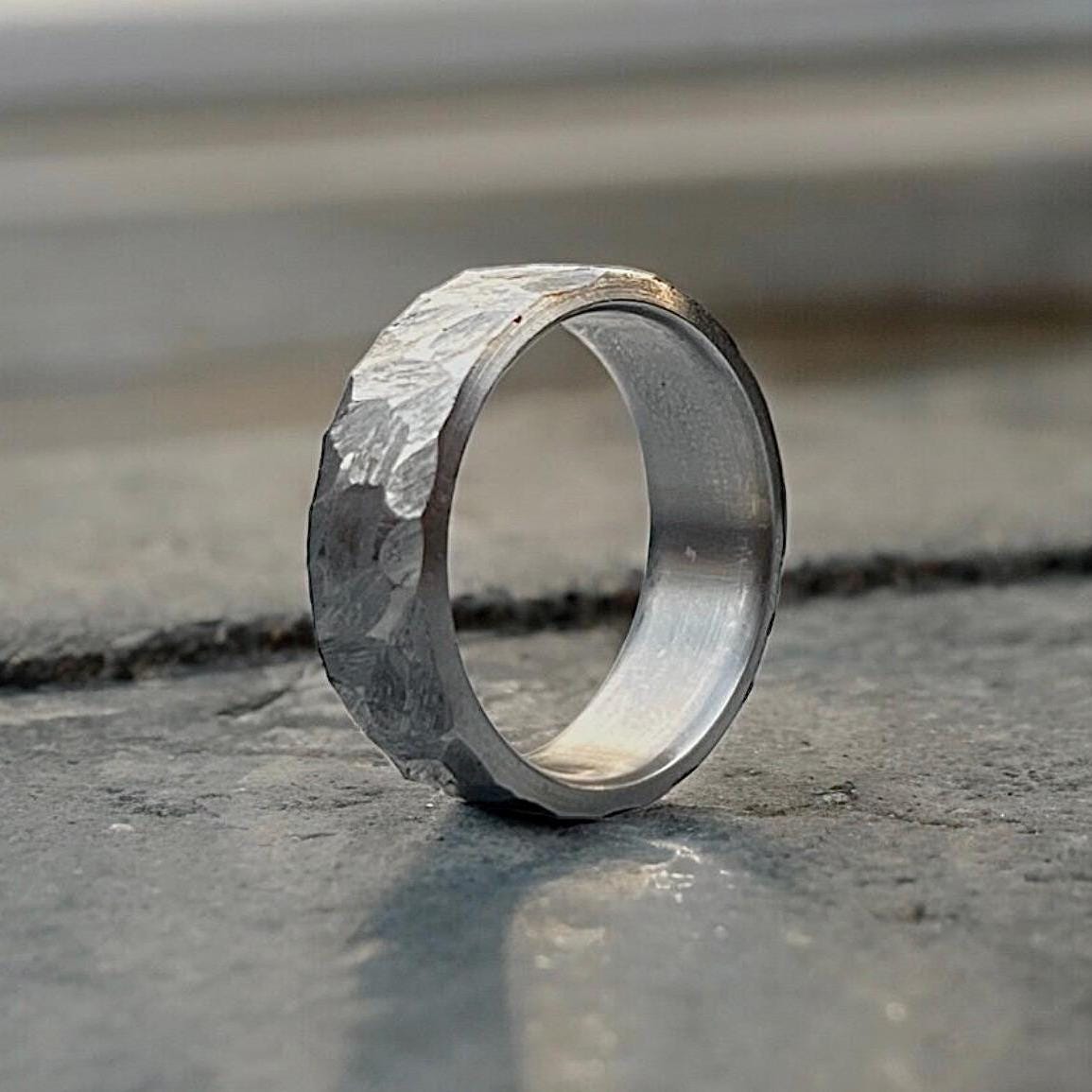 Silver ring with a textured surface on a concrete surface