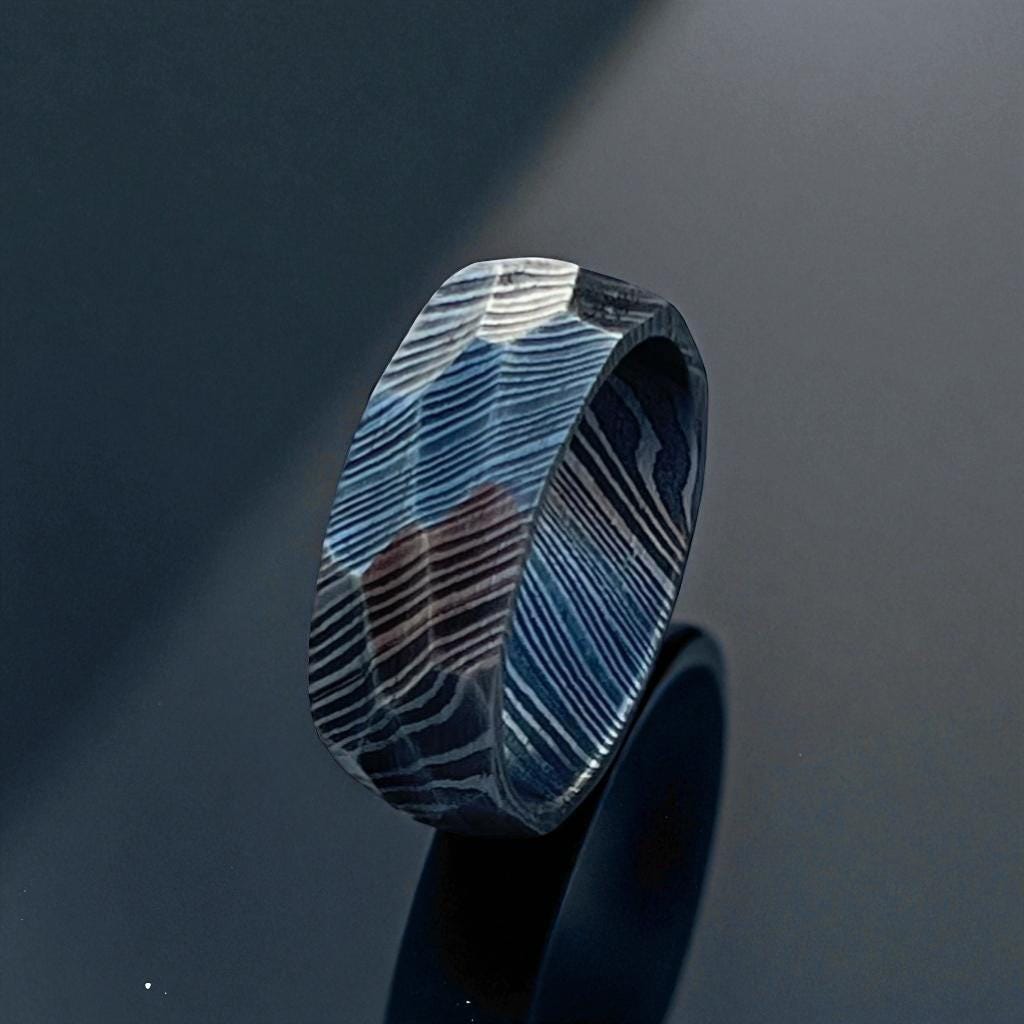 Blue and black patterned ring on a dark background